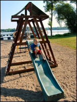 Photo of child playing on playground on the beach