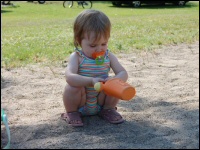 Photo of toddler playing on the beach