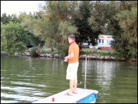 Photo of a man fishing off the dock