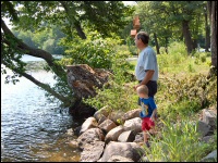 Grandfather and grandson watching the water